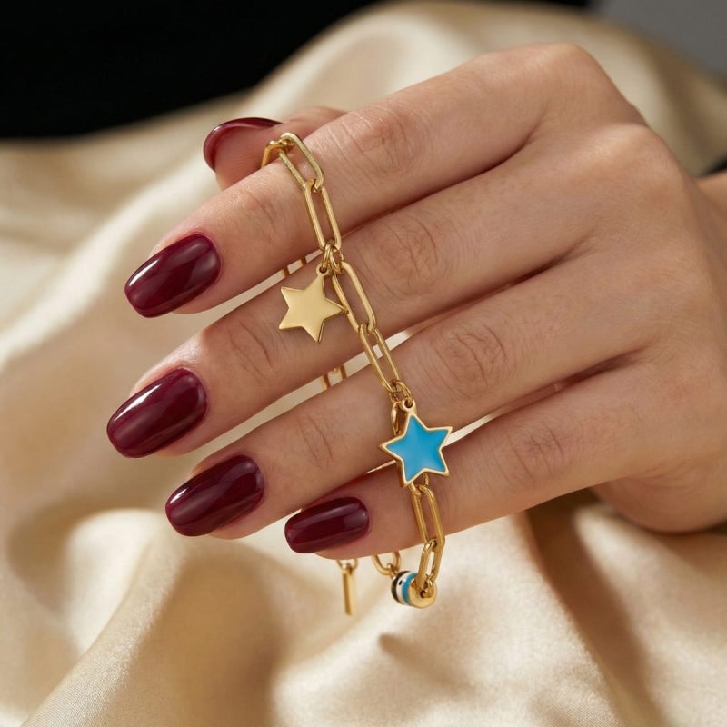 A stylish gold bracelet, crafted from rust-resistant stainless steel, featuring a modern chain design and star-shaped charms (gold and blue). A touch of elegance for your wrist with an adjustable clasp for a perfect fit. - Image 3